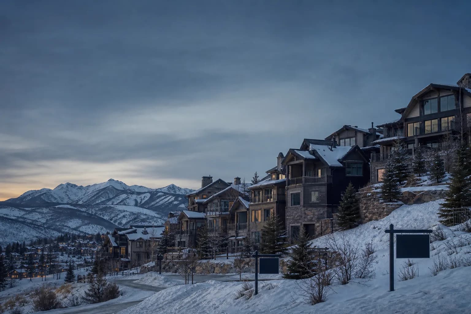 Snow-covered Colorado mountain resort town with empty chalets illustrating falling home prices in 2026